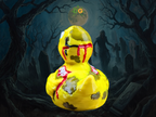 Yellow rubber duck with a bloody design in a dark, eerie landscape with tombstones and a full moon.